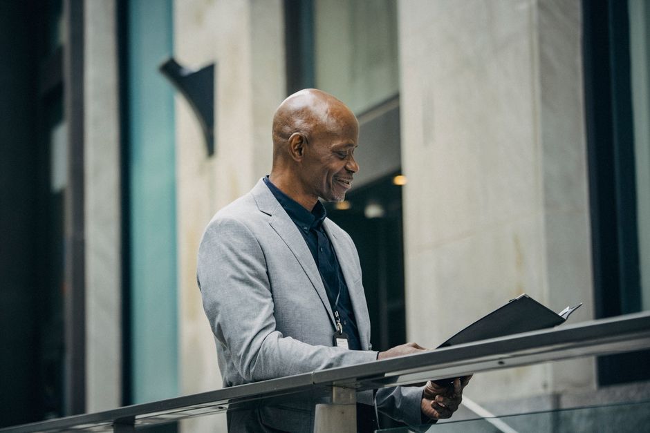 A South African business owner reviewing documents while planning their business